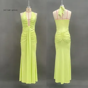 Detailed front and back view of a yellow-green halter neck dress with pleated waist detailing