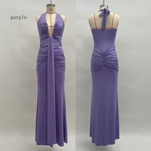 Detail of purple halter neck maxi dress featuring deep V-neck and ruched mermaid silhouette