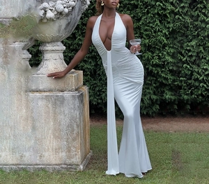 Detail of elegant white halter neck dress featuring a deep V-neck and ruched waist details