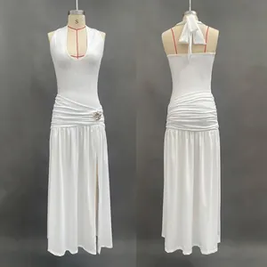 Detail view of white halter neck maxi dress featuring side slit and waist buckle