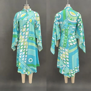 Detailed front and back view of a geometric print long sleeve dress with stand collar