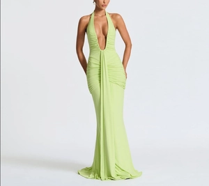 Detail of elegant lime green halter maxi dress with deep V-neck and ruched waist texture