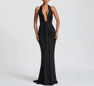 Close-up of ruched detail on elegant black V-neck halter maxi dress with mermaid hem