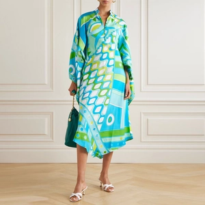 Detail of loose-fit V-neck dress featuring bold geometric prints and asymmetric hemline