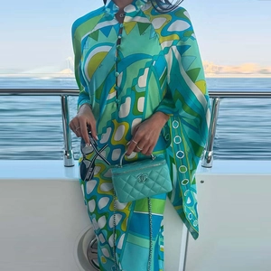 Detail of mandarin collar and button-down front on geometric print satin maxi dress
