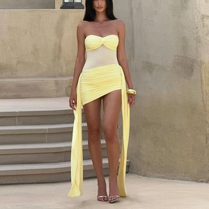 Detail of yellow tube top and skirt set featuring mesh splicing and long side ribbons