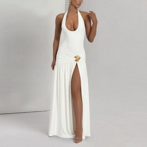 Detail view of white halter maxi dress featuring side gathering and a gold leaf buckle