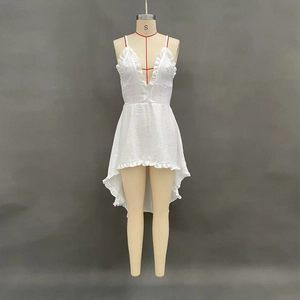 Detail of white high-low summer dress featuring ruffle V-neckline and textured fabric