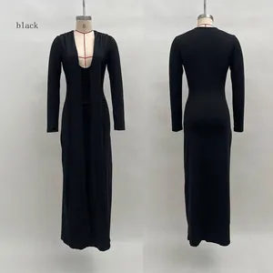 Detail view of the deep V-neck and ruched texture on the black long sleeve slim maxi dress