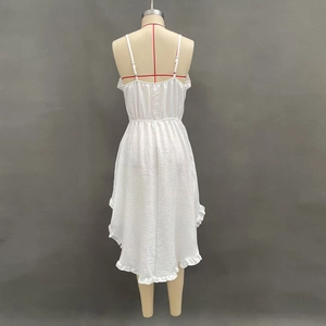 Back view of white summer dress with textured fabric and ruffled asymmetrical hemline