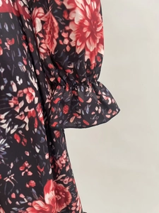 Detailed view of elastic cuffs and floral print on women's long sleeve autumn dress