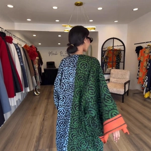 Detail of kimono robe with asymmetric circle patterns and contrasting orange wide cuffs