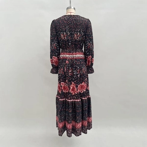 Elegant floral print maxi dress in black with long ruffled sleeves and tiered skirt back