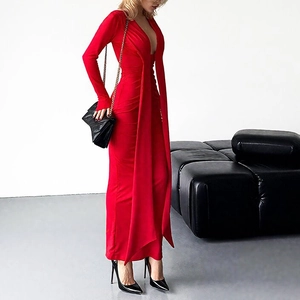 Detail of red long-sleeve dress with deep V-neckline and elegant flowing ribbons