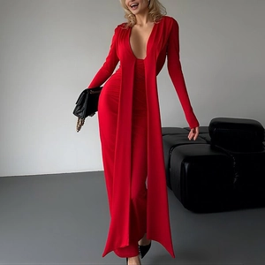 Detail of red deep V-neck evening dress with long sleeves and elegant shoulder ribbons