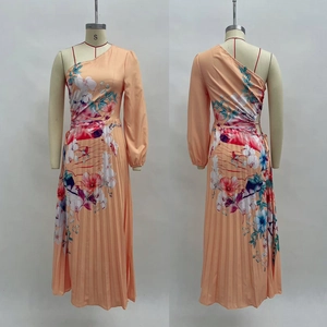 Detail view of one-shoulder pleated maxi dress with vibrant tropical floral print patterns