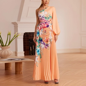 Detail of orange floral pleated maxi dress featuring one-shoulder long puff sleeve