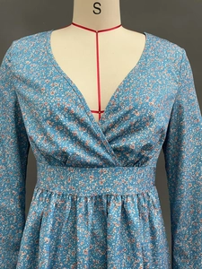 Detail of cross V-neck and floral pattern on high-waist long-sleeved sky blue dress