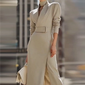 Detail of khaki dress featuring a notched lapel collar and matching waist belt buckle