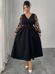 Elegant black V-neck dress featuring sheer lace sleeves with floral embroidery detail