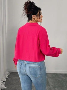 Detail view of pink corduroy jacket showing vertical ribbed texture and drop shoulder design
