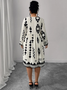 Back view of a bohemian floral print dress with puff sleeves and geometric trim