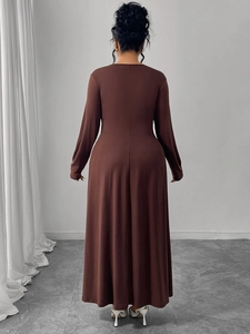 Rear view of a dark brown long-sleeved maxi dress with slim fit waist and A-line skirt