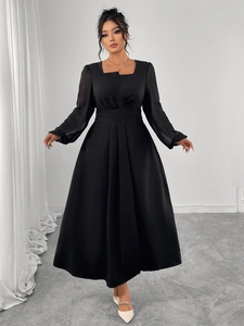 Detail of high waist pleats and square neck on a black French style midi dress