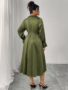 Detail of dark green snake print midi dress showing satin texture and belted waistline