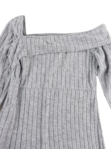 Detail of grey ribbed knit fabric showing asymmetric neck and textured material