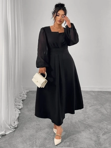 Close-up of black square neck dress featuring pleated waist and sheer lantern sleeves