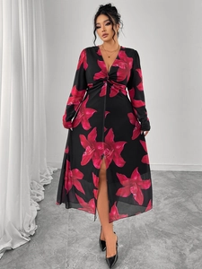 Detailed V-neck floral dress showing red lily prints on black chiffon with a waist tie