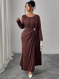Detail of waist-slimming pleats and golden metal buckle on coffee long sleeve dress