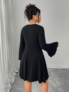 Detailed back view of a black A-line dress featuring elegant flared bell sleeves