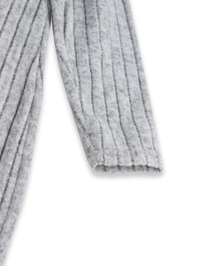 Close-up detail of grey ribbed knit fabric texture and cuff finishing on sleeve