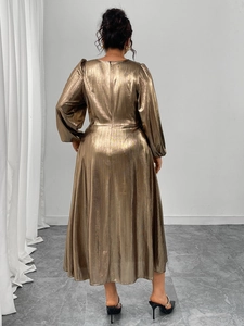 Macro shot of metallic bronze fabric texture on the back of this maxi long sleeve dress