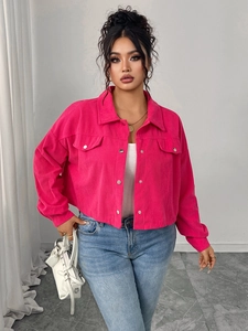 Detail of bright pink corduroy jacket showing texture, metal buttons and flap pockets