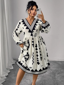 Detail of V-neck long sleeve dress with black and white geometric ethnic pattern