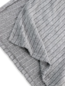 Close-up of gray ribbed knit fabric texture showing high-quality vertical fiber details
