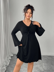 Detail of V-neck with drawstring ruched front and flare sleeves on black mini dress