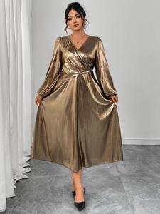 Detail of metallic V-neck pleated dress featuring lantern sleeves and high waist design