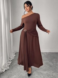 Detail of elegant chocolate brown one-shoulder dress with waist pleats and metal buckle