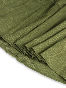 Detailed macro of olive green leopard jacquard satin fabric with elegant silk texture