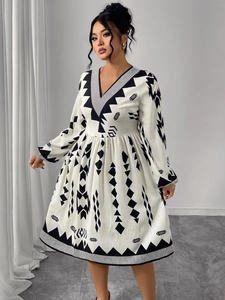 Detail of V-neckline and geometric tribal print on a white puff sleeve dress