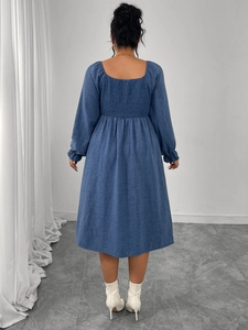 Detail of the square-neck back and smocked high waist of the blue long-sleeve dress