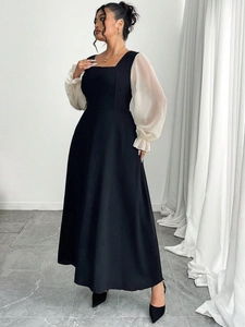 Détail de robe noire évasée avec encolure carrée et manches bouffantes blanches en tulle