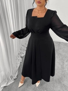 Detailed view of the square neckline and semi-sheer chiffon sleeves on a black dress