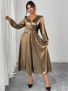 Detail view of metallic pleated dress with lantern sleeves and plunging V-neckline
