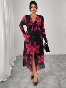 Close-up of a deep V-neck black floral maxi dress with twist detail and front slit design