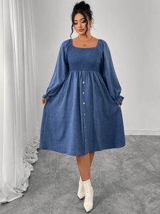 Detail of square neck blue dress with ruched bodice and decorative front buttons